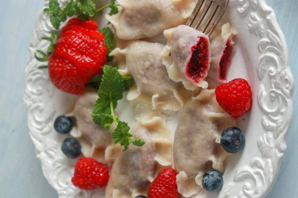mixed berry pierogi on a white plate