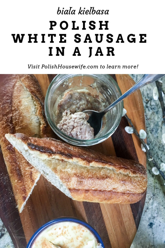 sausage in a jar, butter, and a baguette on a cutting board