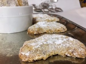 Polish Almond Crescent Cookies (Migdałowe Półksiężyce) coolies on a an enraved silver platter
