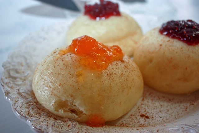 Polish steamed dumplings sprinkled with cinnamon and topped with colorful jam