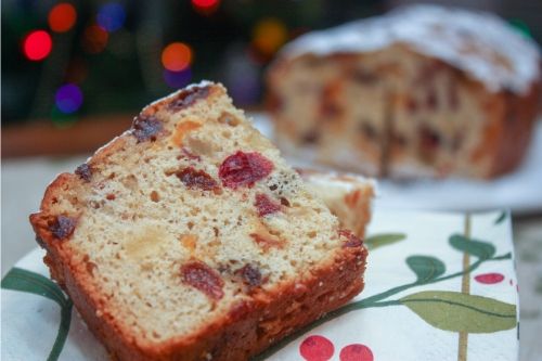 Polish fruitcake with tea on a holiday napklin in front of a christmas tree