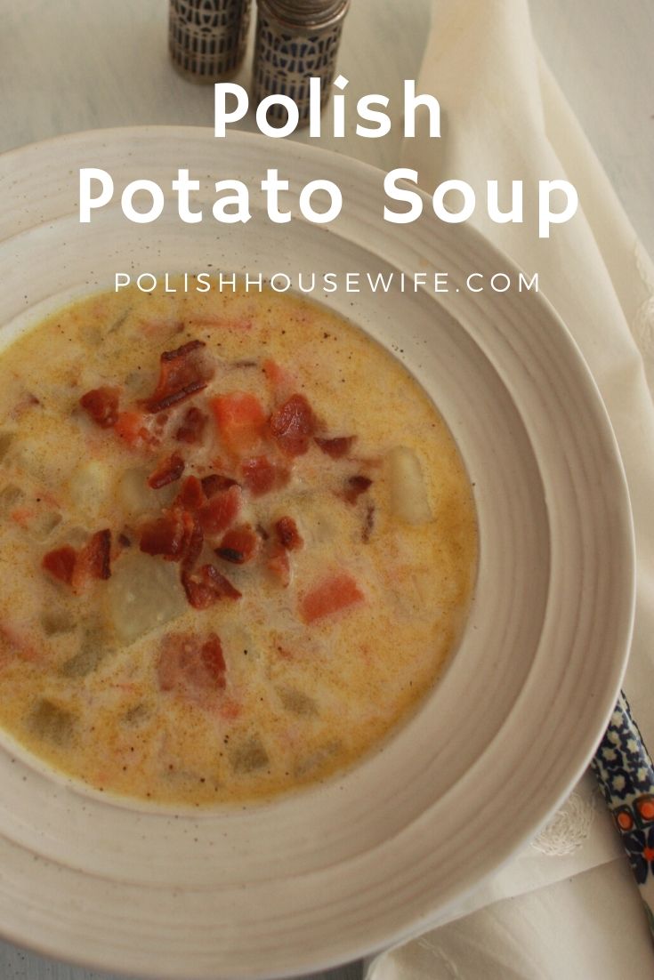 Polish potato soup topped with bacon in a white bowl