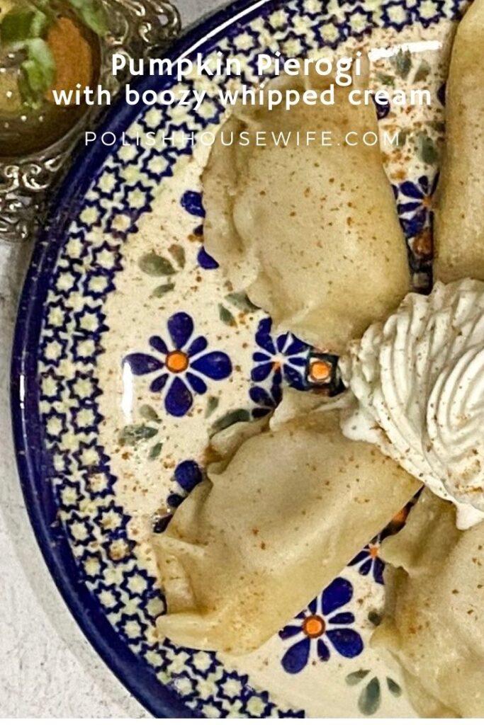 sweet pumpkin filled pierogi and whipped cream on a Polish pottery plate
